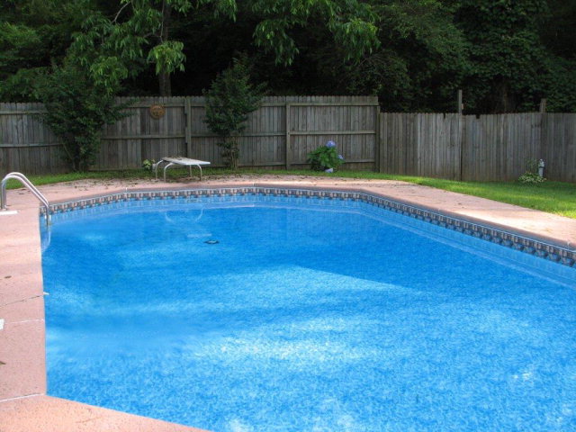 5798 Huddersfield Road Macon, GA 31210 - Photo 31 of 35 a view of a backyard with a small cabin and a chair