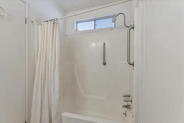 a view of a balcony with wooden floor and fence