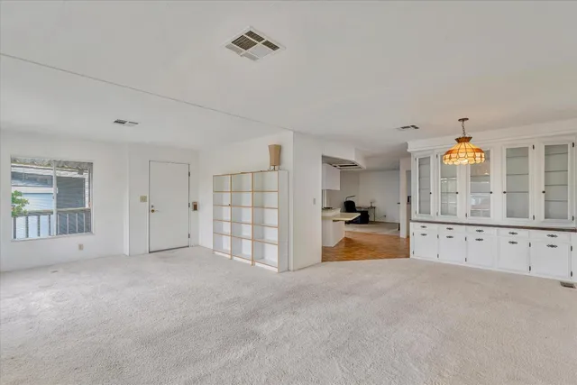 a view of a big room with closet and windows