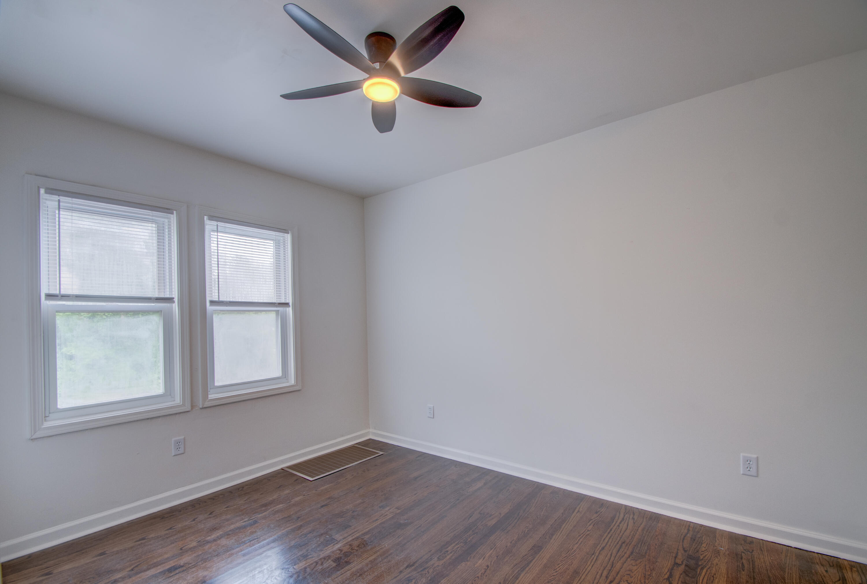 613 Tennessee Street Gary, IN 46402 - Photo 32 of 39 an empty room with wooden floor and windows