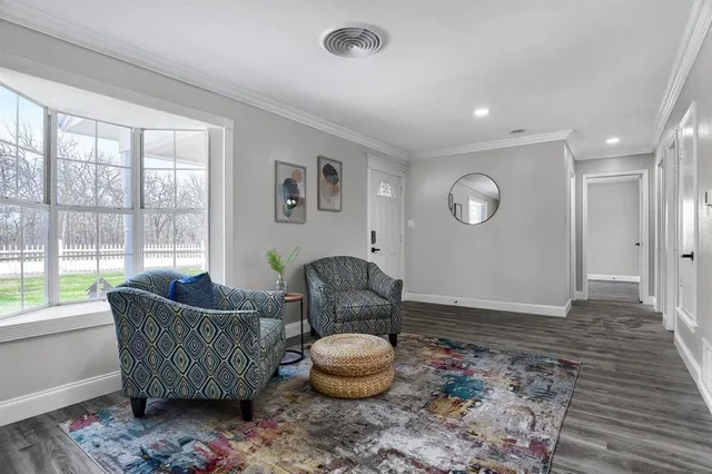 a kitchen with stainless steel appliances granite countertop a refrigerator a stove a sink dishwasher and a dining table with wooden floor