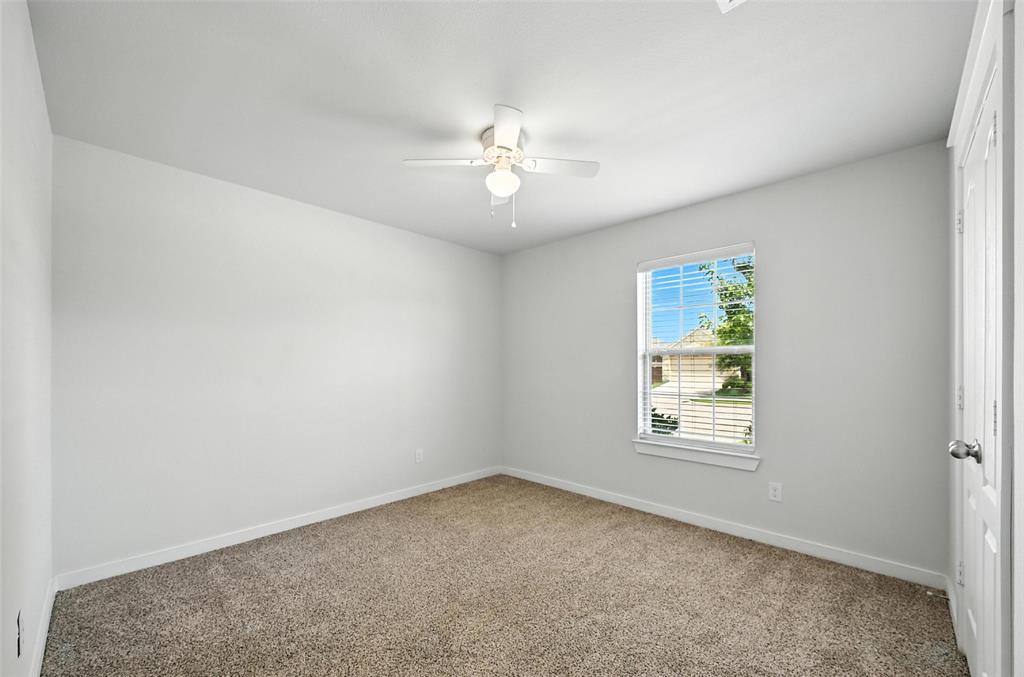 5019 Flanagan Drive Forney, TX 75126 - Photo 12 of 19 an empty room with a window and a fan