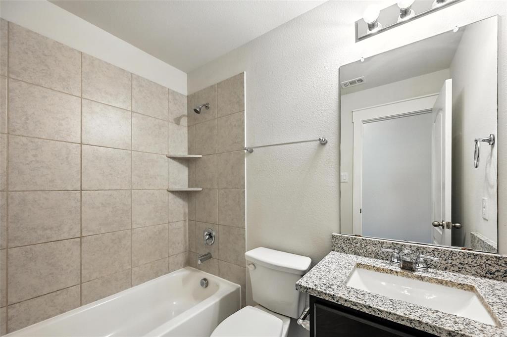5019 Flanagan Drive Forney, TX 75126 - Photo 13 of 19 a bathroom with a granite countertop sink and a toilet