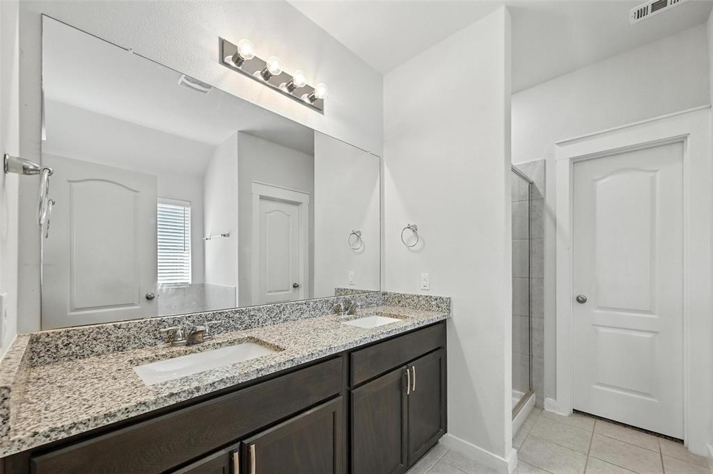 5019 Flanagan Drive Forney, TX 75126 - Photo 14 of 19 a bathroom with a granite countertop sink and a mirror