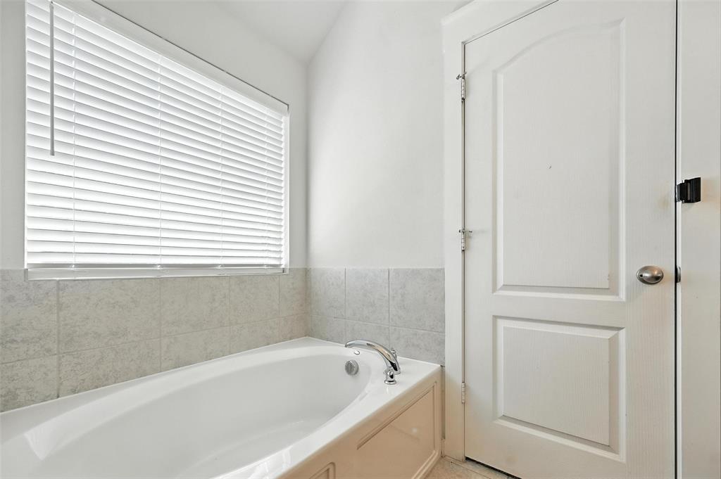 5019 Flanagan Drive Forney, TX 75126 - Photo 15 of 19 a bathroom with a bathtub and a shower