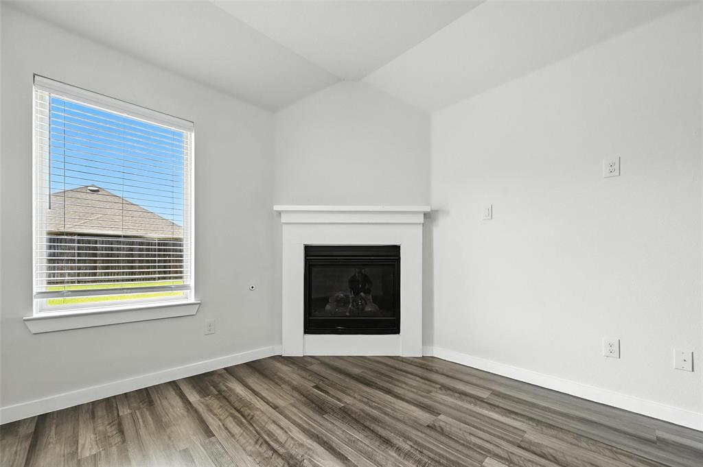 5019 Flanagan Drive Forney, TX 75126 - Photo 2 of 19 a view of an empty room with wooden floor and a window