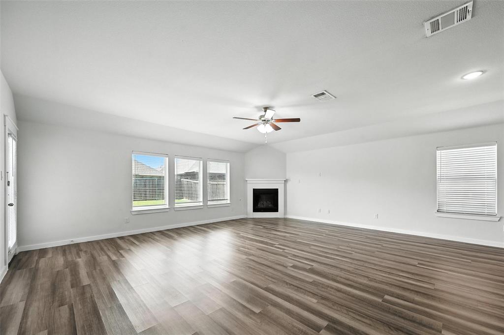 5019 Flanagan Drive Forney, TX 75126 - Photo 3 of 19 wooden floor in an empty room with a window