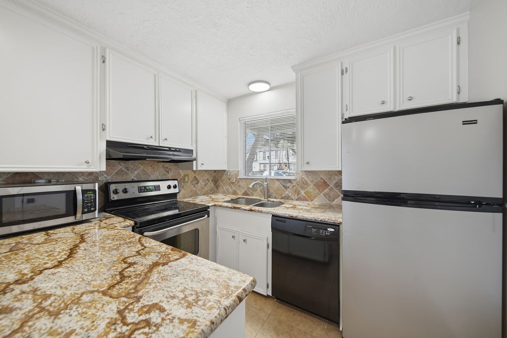 1408 Ramada Drive Houston, TX 77062 - Photo 15 of 28 a kitchen with granite countertop a refrigerator sink stove and oven