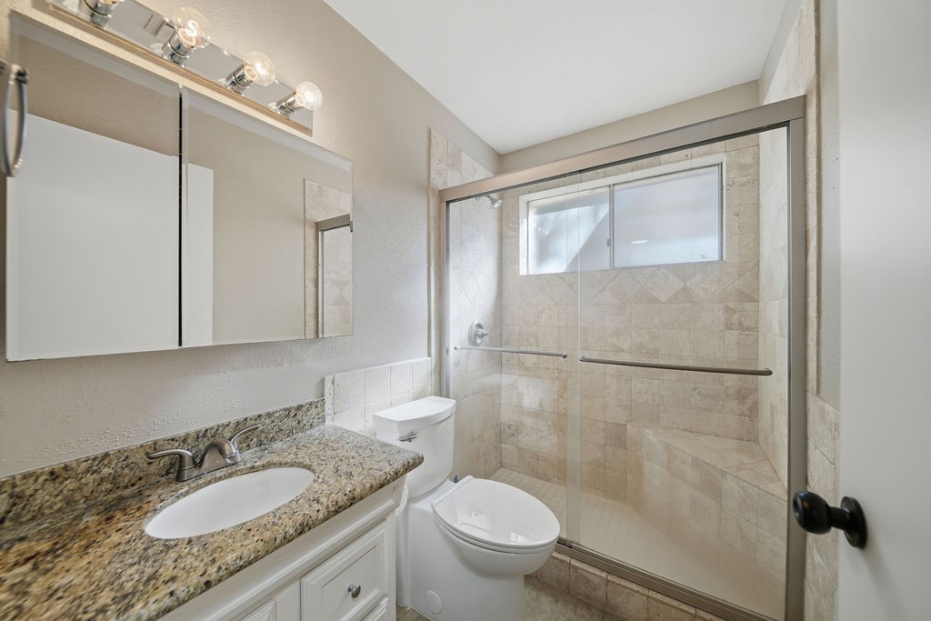 1408 Ramada Drive Houston, TX 77062 - Photo 16 of 28 a bathroom with a granite countertop sink toilet and shower