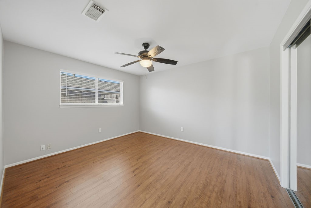 1408 Ramada Drive Houston, TX 77062 - Photo 17 of 28 wooden floor in an empty room with a window