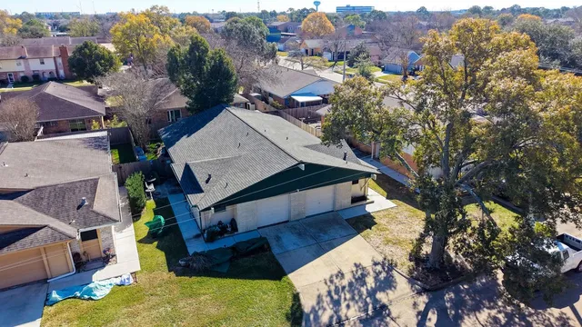 an aerial view of a house with a yard basket ball court and outdoor seating