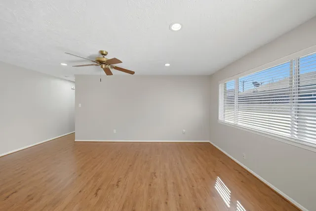 a view of a room with wooden floor and white walls