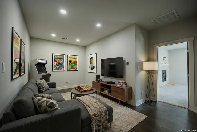 an empty room with wooden floor & windows