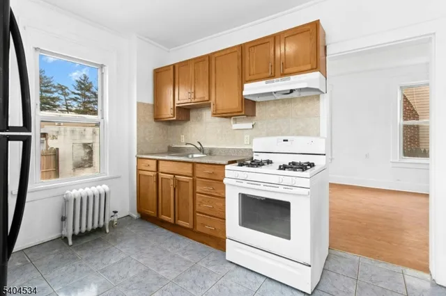 a kitchen with a stove oven and sink