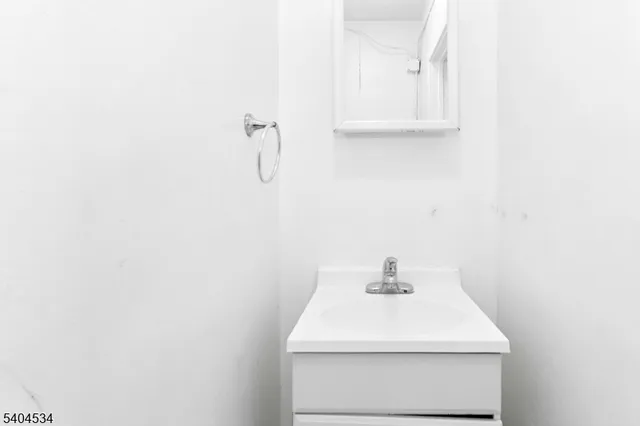 a bathroom with a sink a vanity and a mirror