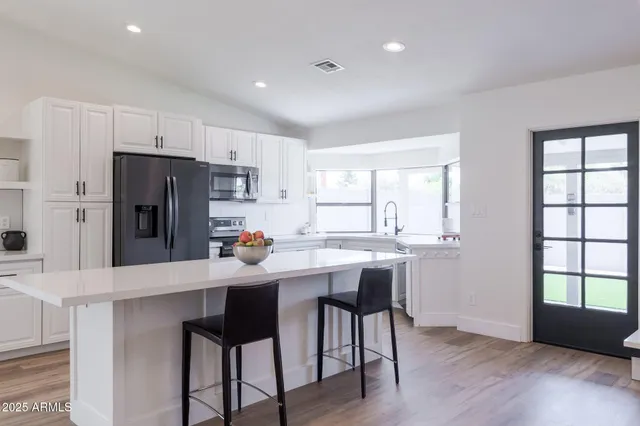 a kitchen with refrigerator and windows