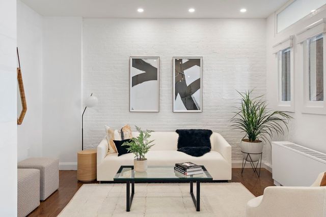 a living room with furniture and a potted plant