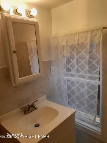 a white toilet sitting next to a sink