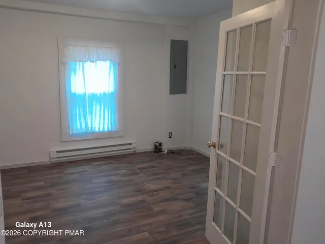 wooden floor in an empty room with a window