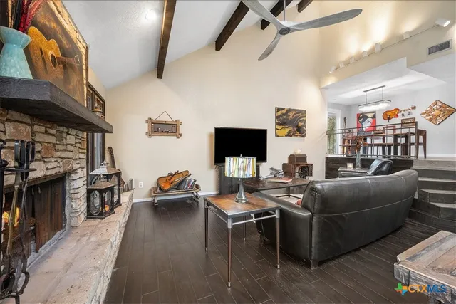 a living room with furniture fireplace and a large window