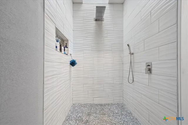 a spacious bathroom with a sink a mirror and a shower