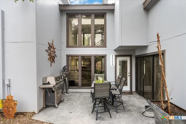 a backyard of a house with table and chairs