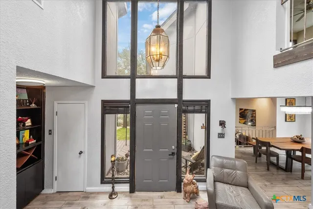 a living room with furniture a bookshelf and a clock