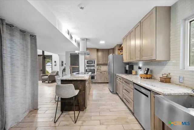 a kitchen with a sink stove and refrigerator