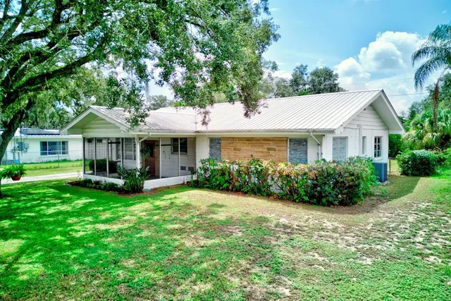 a front view of a house with a yard and porch