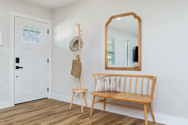 a large kitchen with stainless steel appliances granite countertop a stove top oven a sink dishwasher and a microwave oven with wooden floor