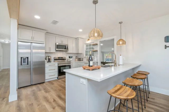 a living room with furniture chandelier and a window