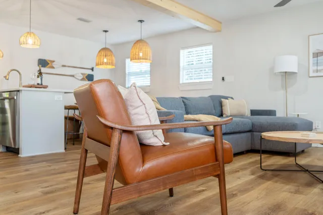 a living room with furniture a window and a table