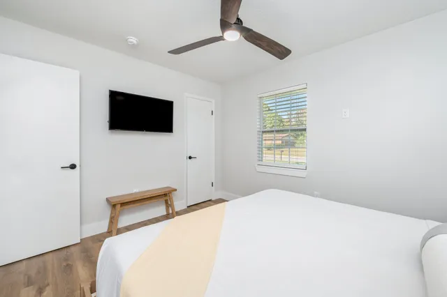 a front view of a house with garden and trees