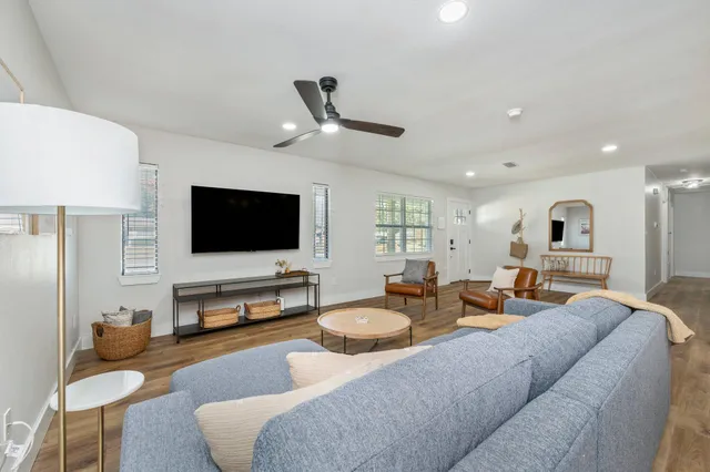 a living room with furniture and a wooden floor