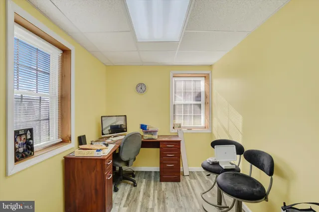 a view of a workspace with furniture and a window