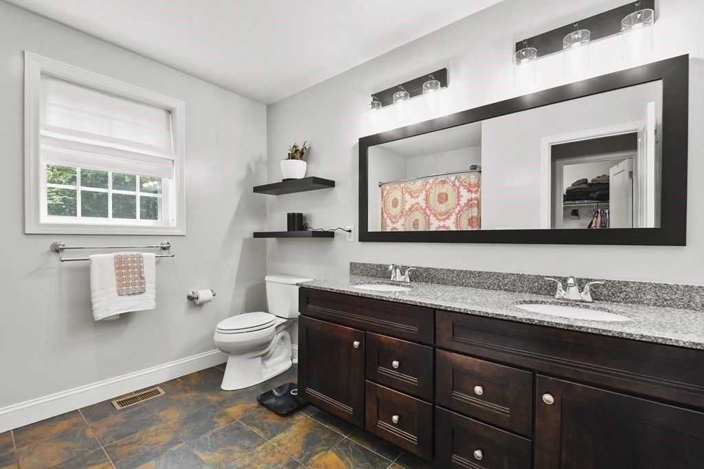 7 Buckland Road Windham, NH 03087 - Photo 20 of 39 a bathroom with a toilet sink and mirror