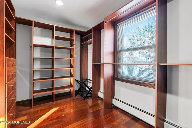 a view of room with window and wooden floor