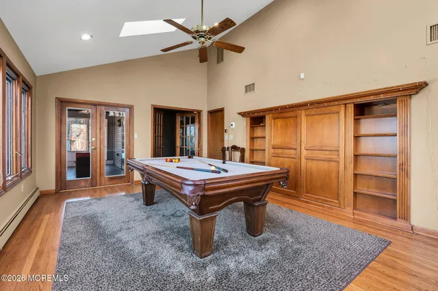 a room with pool table and windows