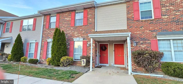 a front view of multi story residential apartment building with yard