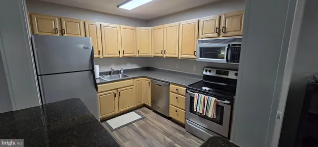 a kitchen with stainless steel appliances a refrigerator sink and cabinets