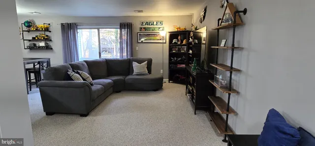 a living room with furniture cabinets and a window