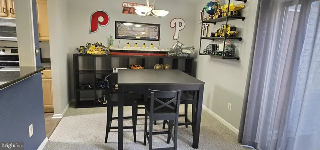 a dining room with furniture and a flat screen tv