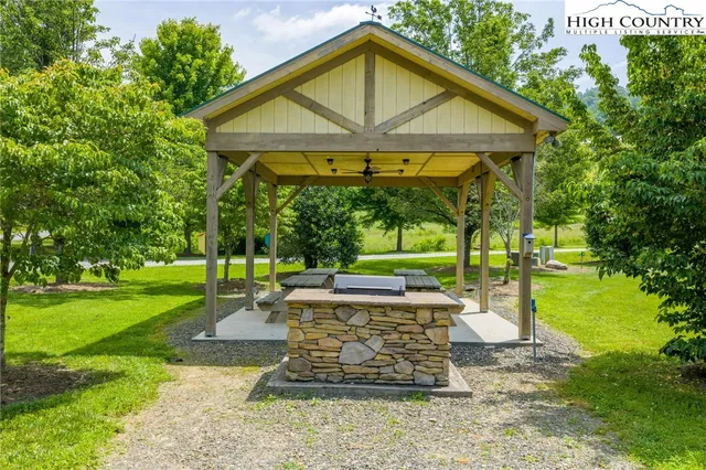 a view of a chair and table in backyard of the house