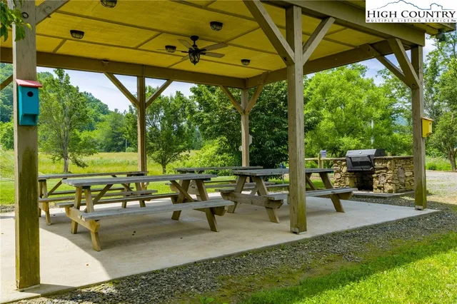 a view of a patio with couches chairs and a big yard