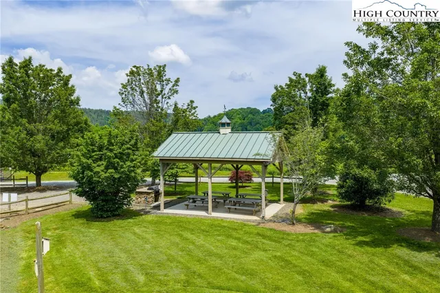 a view of a house with a yard and a garden