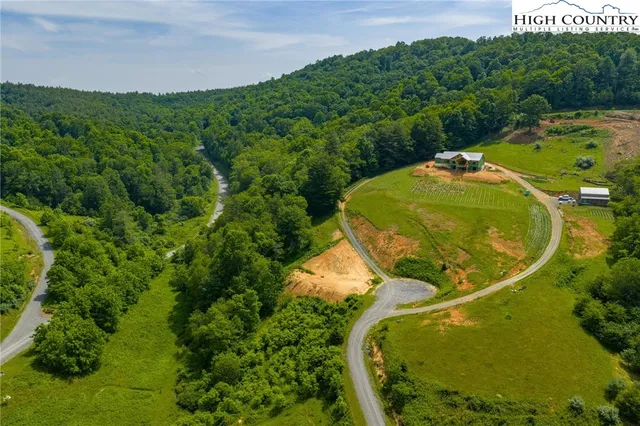 a view of a swimming pool with a yard and outdoor seating