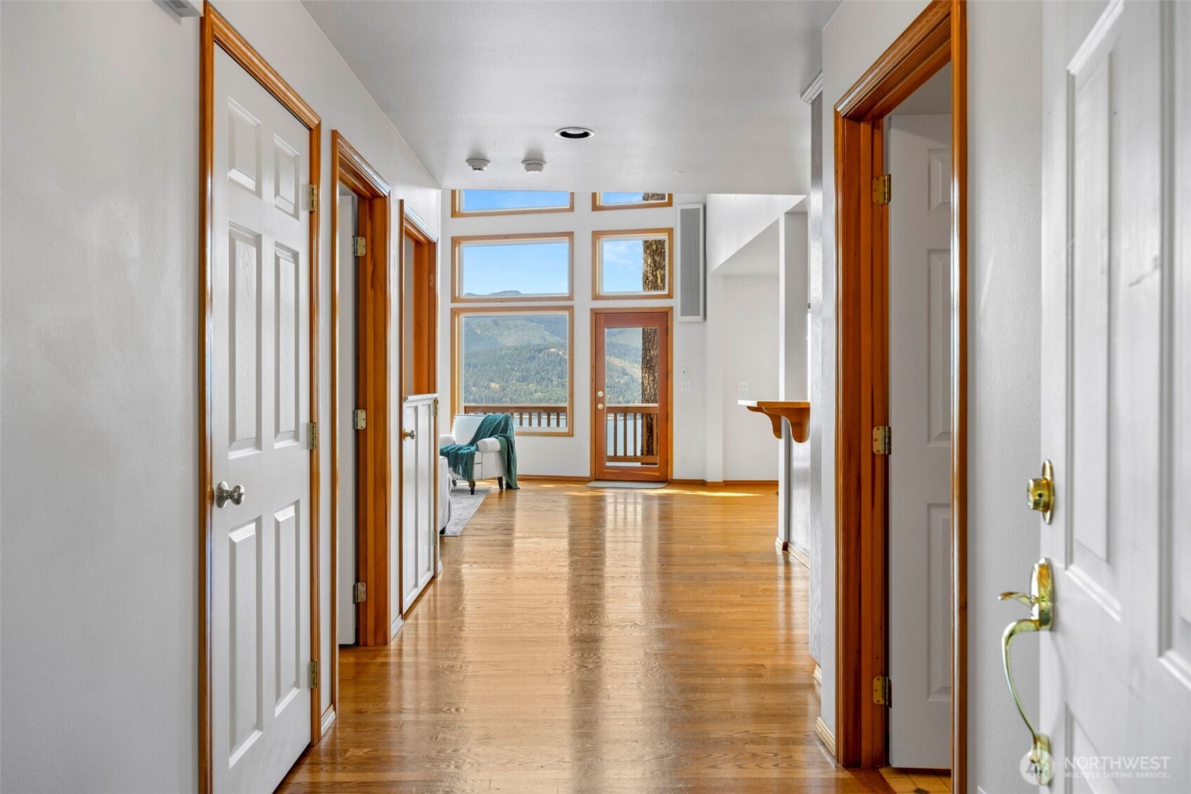 19736 Northwest Stavis Bay Road Seabeck, WA 98380 - Photo 4 of 39 a view of front door and porch with wooden floor