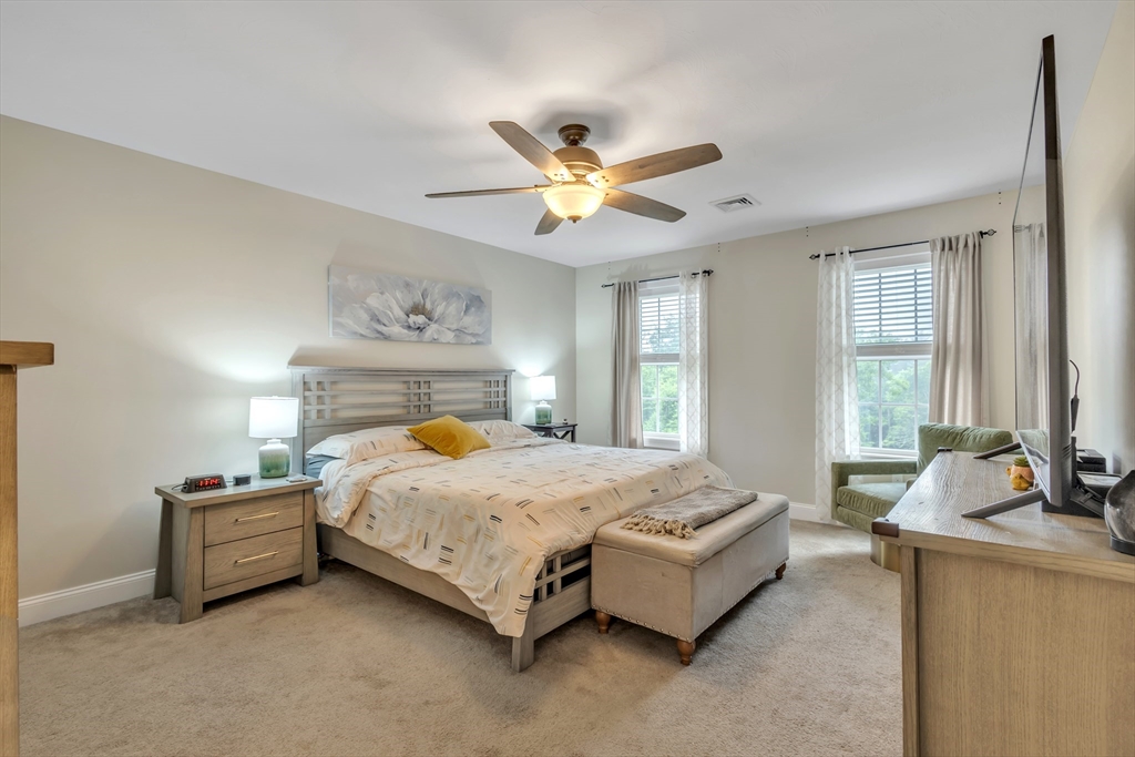 24 Old County Road Ashburnham, MA 01430 - Photo 12 of 32 a bedroom with a bed and a chandelier