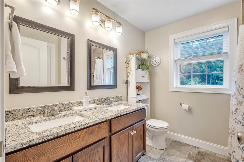 24 Old County Road Ashburnham, MA 01430 - Photo 14 of 32 a bathroom with a granite countertop toilet sink and mirror
