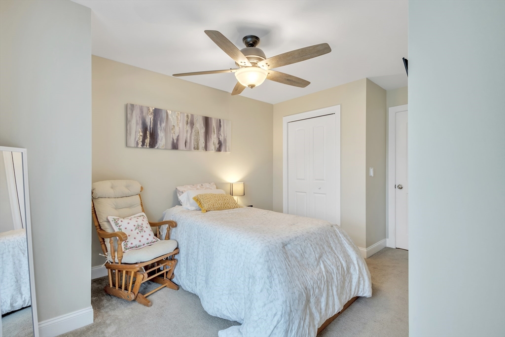 24 Old County Road Ashburnham, MA 01430 - Photo 16 of 32 a bedroom with a bed and a ceiling fan